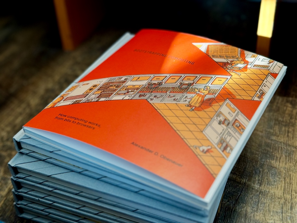 Paperback on stack of hardcovers